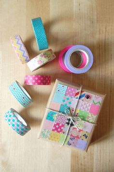 several different types of washi tapes and tape on a wooden table with one roll of tape