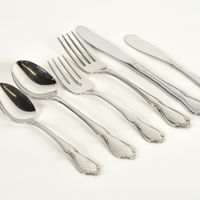 an assortment of forks and spoons on a white surface