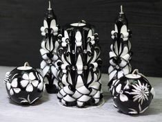 a group of black and white vases sitting next to each other on a table