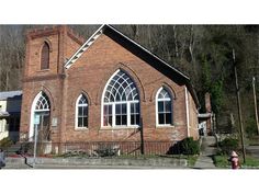 an old red brick church with arched windows