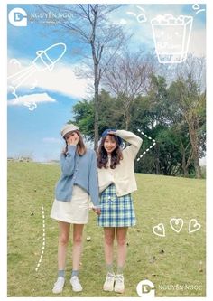 two young women standing next to each other on top of a grass covered field with trees in the background