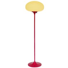 a red floor lamp with a yellow light on it's base and a white background