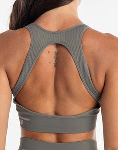 the back of a woman's gray sports bra