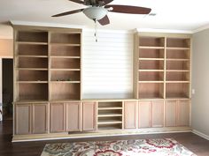 a living room filled with lots of wooden furniture and a ceiling fan in the corner