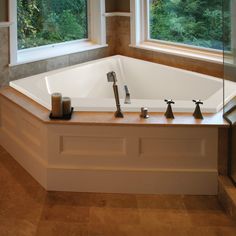 a large bath tub sitting next to two windows