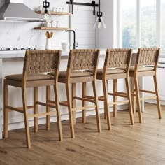 four wooden chairs are lined up in front of the kitchen counter and stove top oven