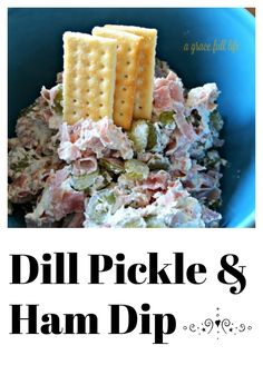 dill pickle and ham dip with crackers on top in a blue bowl