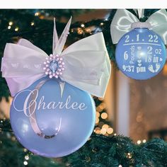 an ornament hanging from a christmas tree with a baby's name on it