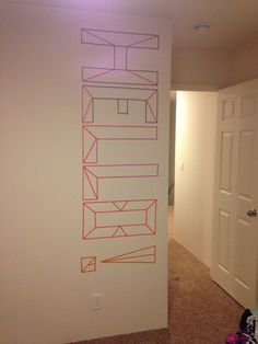 a wall with lines drawn on it next to a door in an empty living room