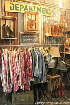 an old fashioned clothing store with clothes hanging on racks