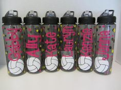 four water bottles with volleyball designs on them