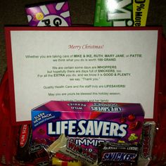 a red basket filled with candy next to a sign that says lifesavers dynamite