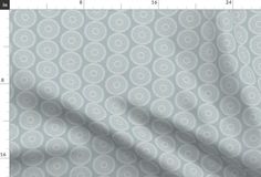 an image of a white and grey fabric with circles on the side, as well as a ruler