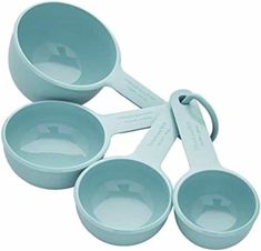 four blue measuring cups with spoons in them