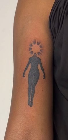 a person with a tattoo on their arm that has an image of a man's body