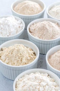 six white bowls filled with different types of food and one bowl has rice in it