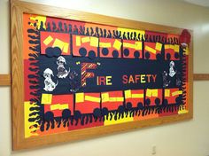 an art piece is hanging on the wall in front of a sign that says fire safety