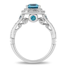 a blue topazte and diamond ring with an intricate design on the band, set in