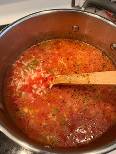 a wooden spoon in a pot filled with soup