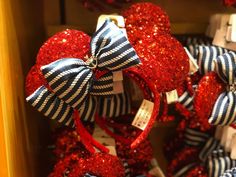 red, black and white minnie mouse ears are stacked on top of each other with bows