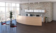 an office with a brick wall and wooden flooring is shown in this image, there are chairs around the desk