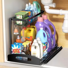 an open dishwasher drawer filled with cleaning products and household detergents,