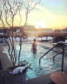 a man in a swimming pool at sunset