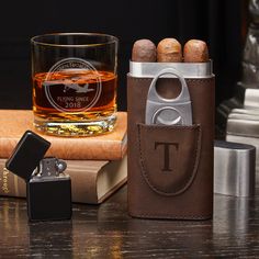 a leather case with a lighter and some cigars in it next to a bottle opener