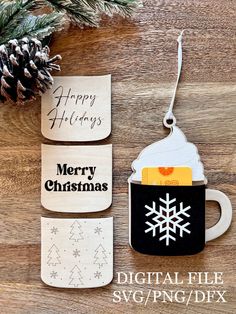 two mugs with merry christmas tags on them and a pine cone hanging from the top