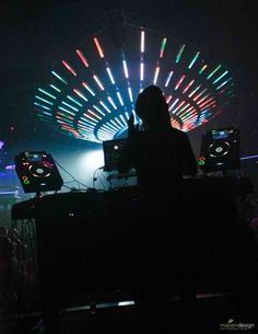 a person standing in front of a stage with lights on it