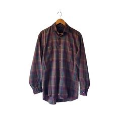 ○ This timeless vintage Nordstrom burgundy tartan plaid shirt features long sleeves, two chest pockets, and a classic button-up design. Perfect for a sophisticated yet casual look. ○ Material: 100% cotton ○ Size on the label: 15 - 33 ○ Measurements (taken flat) pit to pit: 23" sleeve length (from armpit seam): 21.5" shoulder seam: 20.5" total length (from the back neck): 34" ○ In great vintage condition. Some marks near the label. No other visible flaws. Please look at the pictures since they ar Button Up Top, Shirt Long Sleeve, Tartan Plaid, Classic Vintage, Plaid Shirt, The Label, Tartan, Casual Looks, Top Shirt