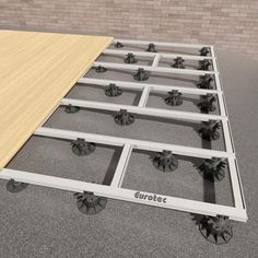 a metal bed frame with wheels on the floor