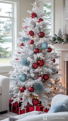 a white christmas tree with red and blue ornaments