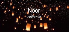 the words noor radiance are lit up in the dark sky with lanterns floating above