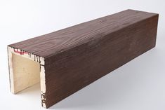 a piece of wood that has been cut in half and is brown with white trim