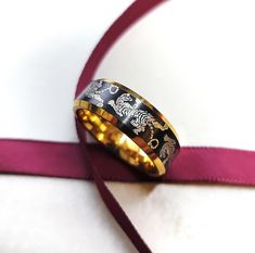 "The tiger pattern will engrave black/dark gray on silver/yellow gold/rose gold. We recommend a ring with a black center for the cleanest smoothest look. This is a crawling tiger pattern engraved ring, with a beautiful tiger design going around the entire ring. ALL OF OUR RINGS ARE SOURCED IN THE USA :] All of our rings are deep cleaned (sanitized) before shipment in a cleanroom! Have a design or modification? Just message us or email us at veiljewelers@gmail.com! ABOUT OUR ENGRAVINGS Our engrav Black Etched Rings As A Gift, Tiger Ring, Tiger Gifts, Tiger Design, Tungsten Carbide, Engraved Rings, Black Rings, Dark Black, Leather Bracelet