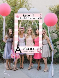 a group of women standing next to each other in front of a sign that says happily ever after