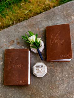 the wedding rings and boutonnieres are laid out on the ground next to each other