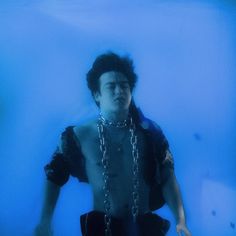 a man with chains around his neck in the water