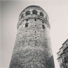 a tall brick tower next to two buildings