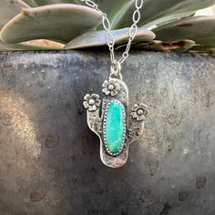 "The Saguaro Cactus pendant is a fun and cute accessory to add to any collection. It is solid sterling silver back with hand stamped bordered thorns set with an oval piece of natural turquoise. The sterling silver flower blooms add extra flare to this unique piece. The Saguaro Cactus pendant measures approximately 1.25\" high and 1\" at its widest point. The Saguaro Cactus pendant can be purchased as a pendant only or as shown on an 18\" oxidized long/short chain.  *NO two pieces of turquoise ar Native Ancestors, Navajo Silver Jewelry, Turquoise Tuesday, Santa Fe Jewelry, Cactus Necklace, Cowgirl Accessories, Cowgirl Fashion, Cowgirl Bling, Cowgirl Jewelry