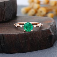 a green ring sitting on top of a wooden table