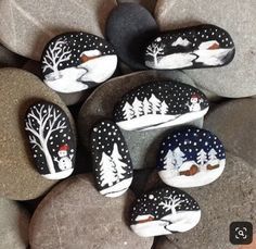 painted rocks with trees and snow on them are arranged in the shape of animals sitting on top of each other