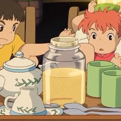 two children sitting at a table with jars and cups