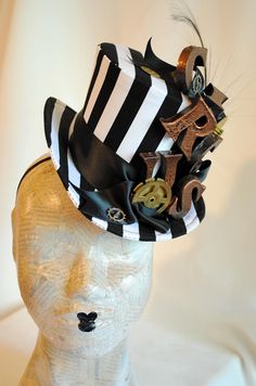 "This playful steampunk circus themed mini top hat is covered with black and white striped fabric. It is embellished with copper toned letters that spell the word \"CIRCUS\", placed vertically, over lush black satin ribbon, among some stunning and huge vintage alarm clock gears. This striking costume mini top hat wouldn't be complete without a beautiful black burnt ostrich feather. Measurements : height 4 inches( 10 cm ) front to back 9 inches ( 22 cm ) side to side 7.5 inches ( 19 cm ) This min Black Steampunk Costume Accessories For Themed Events, Black Punk Top Hat For Alternative Fashion, Steampunk Costume Hats And Headpieces For Carnival, Black Steampunk Costume Accessories For Carnival, Steampunk Adjustable Top Hat For Alternative Fashion, Steampunk Black Costume Accessories For Carnival, Adjustable Steampunk Top Hat For Alternative Fashion, Vintage Black Hat For Alternative Fashion, Black Novelty Mini Hats For Themed Events