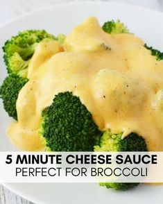 broccoli covered in cheese sauce on a white plate