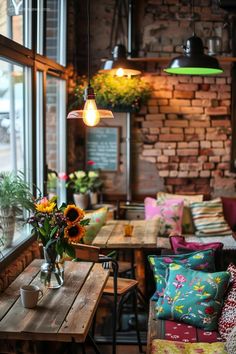 a restaurant with tables, chairs and flowers in vases on the windows sill