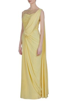 Awash in  mellow yellow hue, this crepe silk elegantly draped saree is enhanced with delicate hand embroidery at the bodice and back. The hand embroidery is created with katdana, crystals and sequins.
One piece saree with draped layer
Hand embroidery
Cutdana work with crystals and sequins
 - Aza Fashions Drape Saree Gowns, Types Of Attire, Saree Style Gown, Draped Saree Gown, Pre Draped Saree, Saree Yellow, Saree Gowns, Drape Sarees, Online Shopping Sarees