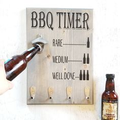 a beer bottle is being held up to a sign that says bbq timer