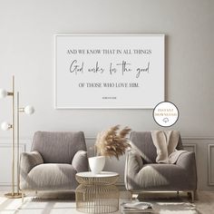 a living room with two gray couches and a quote on the wall above them